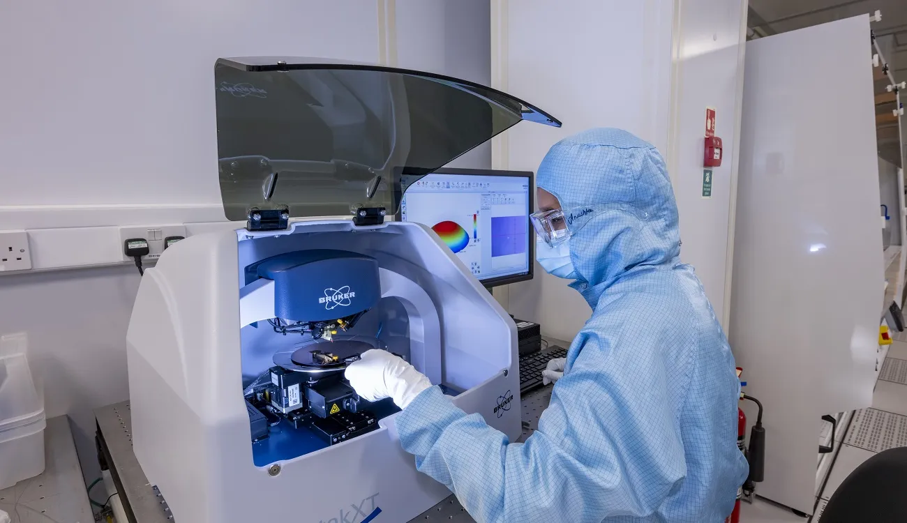 A person working at Bruker Dektak XT Stylus profiler equipment