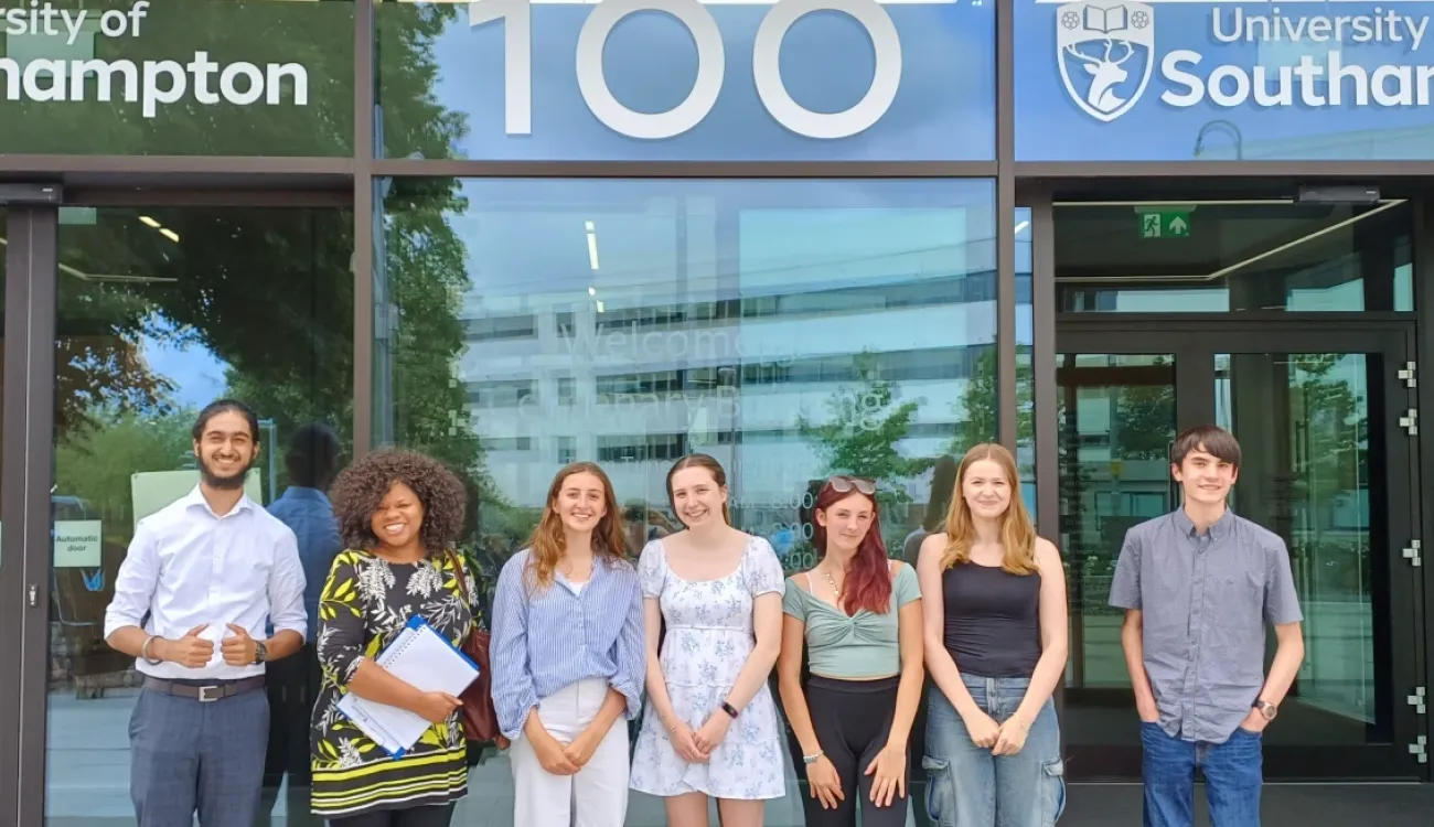 The public contributors who attended the Faculty of Medicine Research Conference in 2023. They all look pleased to be at the conference. They are standing outside the University's new Centenary Building, numbered 100. It is a bright and clear day.