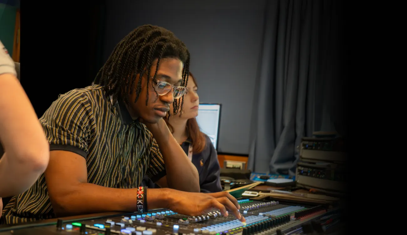 Young person working at mixing desk