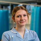 Head and shoulders portrait image of Ella Rawles in her uniform smiling at the camera.