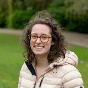 Head and shoulders portrait image of Maria Farmer smiling at the camera.