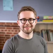 Nick sat smiling for a picture.