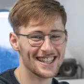 Head and shoulders of Daniel Hampton smiling at the camera.