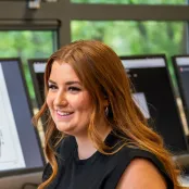 Head and shoulders portrait image of Carly Newell, BA Fashion Marketing with Management student smiling at the camera.