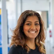 Head and shoulders portrait image of Emy Godfrey, BA Philosophy and Politics student smiling looking at the camera.
