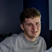 Head and shoulders portrait image of Freddie Barnes-Janes, BA Film and English student smiling at the camera.