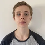 Head and shoulders portrait image of Jamie Purnell, BA Film, TV and Digital Media student looking at the camera.