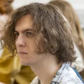 Head and shoulders portrait image of Luca Ringlet, BA Philosophy student looking to the left of the camera.