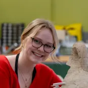Head and shoulders portrait image of Rosemarie Elspass, BA Archaeology and Ancient History student, smiling at the camera.