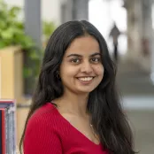 Head and shoulders portrait image of Vrunda Vasani, MA Creative Writing student, smiling at the camera.