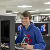 Leon Brindley sitting at an electronic engineering workstation.