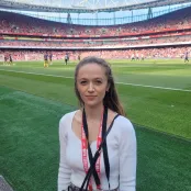 Adele standing on the pitchside at Arsenal's Emirates Stadium during a match warm-up