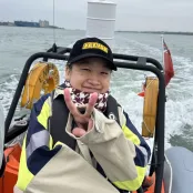 Global Marine Resource Management (MSc) student Jiao on a boat is smiling at the camera.