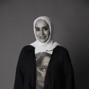 A black and white photo of Salwa looking at the camera