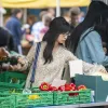 Student shopping for vegetables in the market.