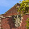 An old stone version of the University of Southampton coat of arms, affixed to the side of Hartley Library.