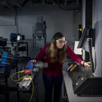 A student uses a piece of equipment in the testing and structures research lab