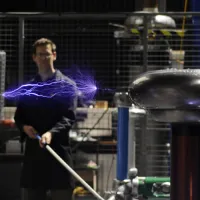 A researcher conducting an electrical experiment in the high voltage lab.