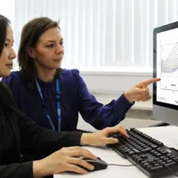 Clinical data researchers compare graphs on a computer screen