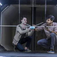 Two researchers experimenting in a wind tunnel