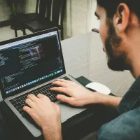 A person coding on their computer