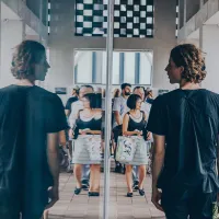 Man looking at his reflection in a window