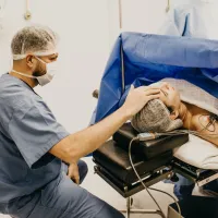 Image of a nurse looking after a patient during surgery. 