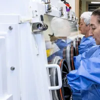 Staff using containment protection equipment