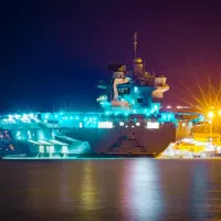 Night time image of a Queen Elizabeth Class Aircraft Carrier docked in Portsmouth Harbour