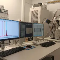 The Focused Ion Beam (FIB) Facility. The image shows three computer screens showing data, with laboratory equipment in the background
