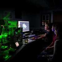 A group os scientists pour over the results of a confocal lightsheet microscopy image