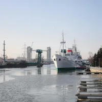 Large ship moored in industrial river scene