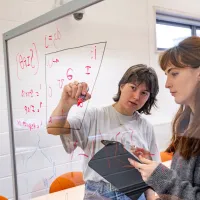 Two students filling in a vowel space with symbols from the International Phonetic Alphabet’