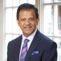Medium shot of Dr Chaand Nagpaul wearing a suit and facing the camera.
