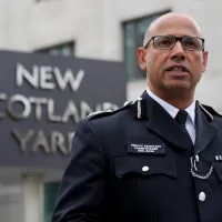 Neil Basu pictured in police uniform in front of New Scotland Yard sign