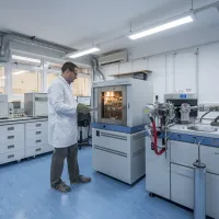 Scientist in a lab coat at the Stable Isotope Lab at the National Oceanography Centre, Southampton.