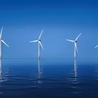 A nice calm, ocean scape with several wind farms