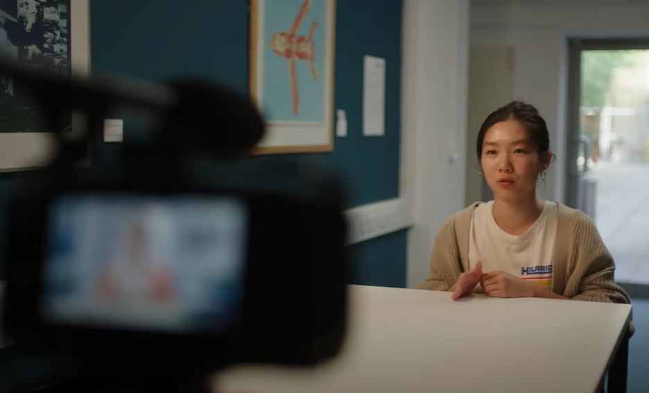 Student sitting at desk being interviewed