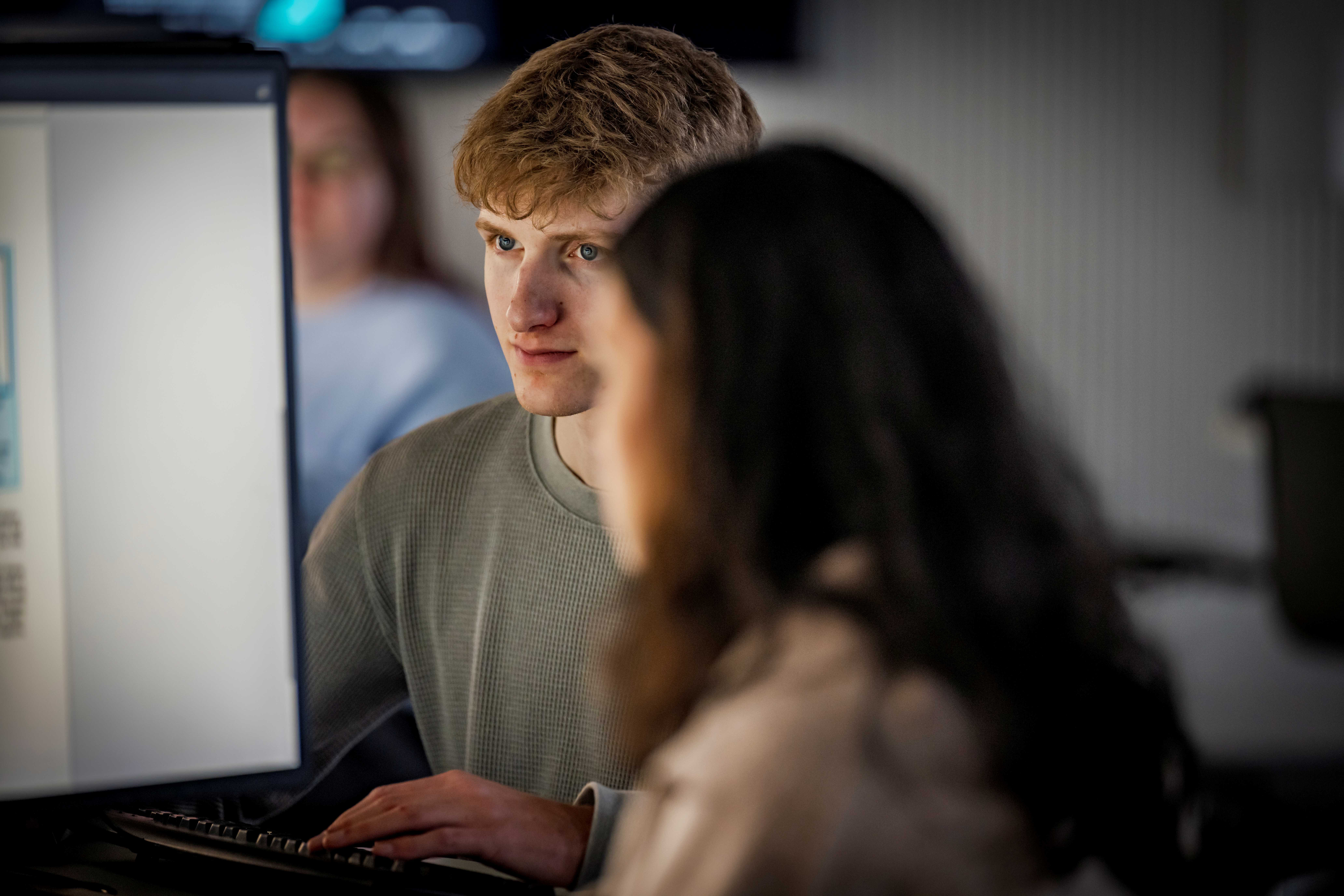 Two students looking at a computer screen.